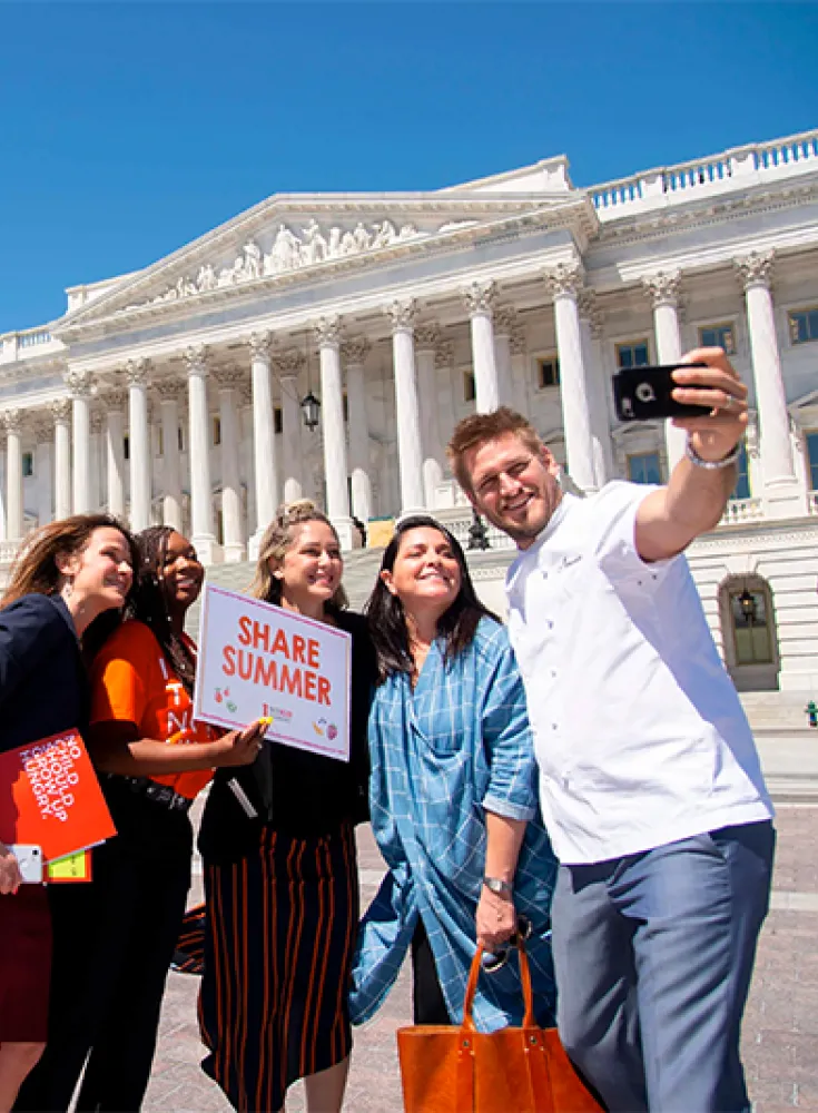 Chefs taking a selfie outside of the Capitol building